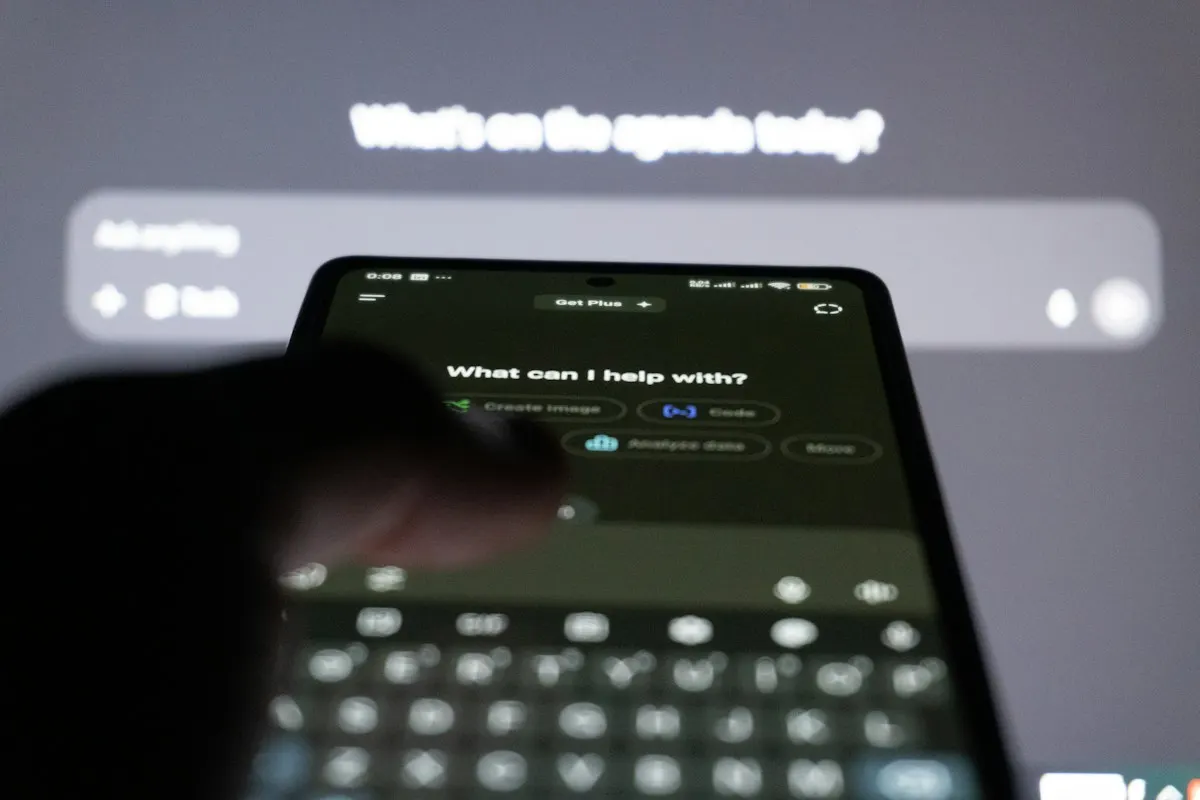 Person typing a question into an AI assistant on a smartphone