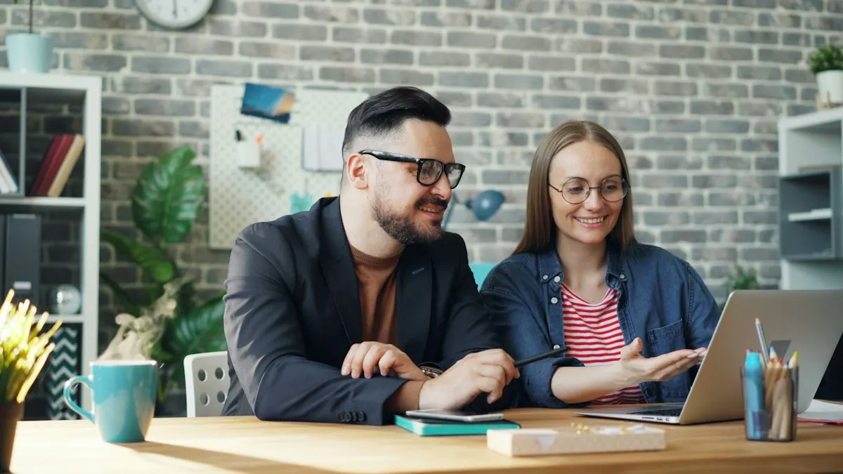 Two business owners smiling as they review their results on a laptop