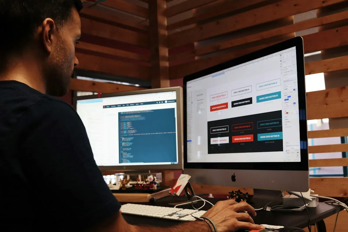 Web designer building a site on a large monitor